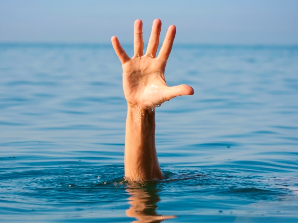 The single hand of a drowning man illustrates how it feels to be out of organizational alignment, as seen by leadership speakers Bob Vanourek & Gregg Vanourek.