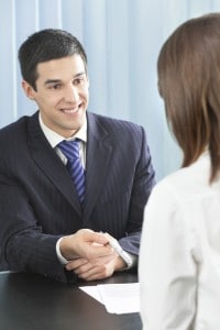 Leadership speaker and author Bob Vanourek uses this image of a smiling man offering a pen to a woman to illustrate the importance of valuing people.