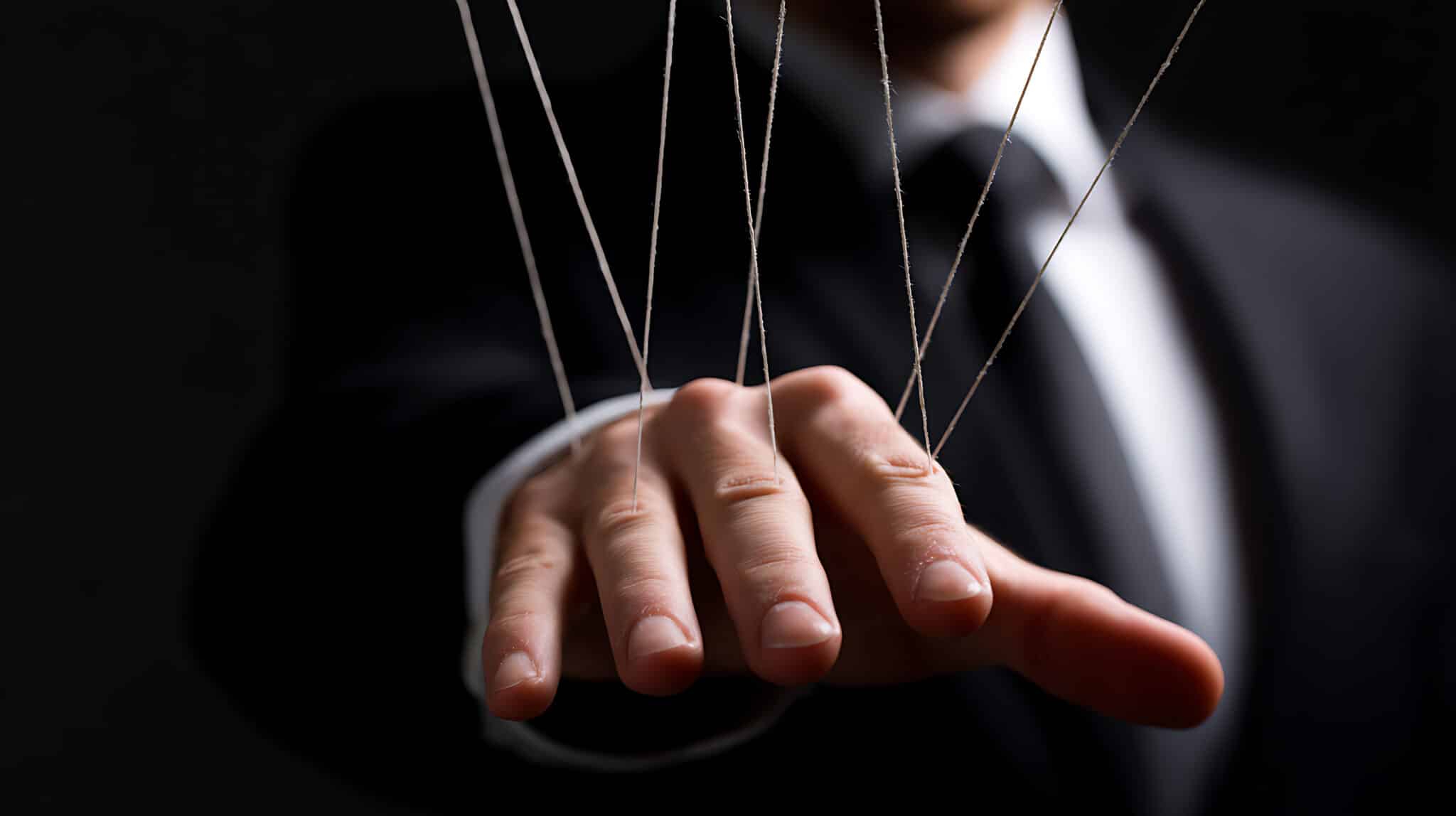 businessman hand controlled by strings like a puppet representing leadership imprinting